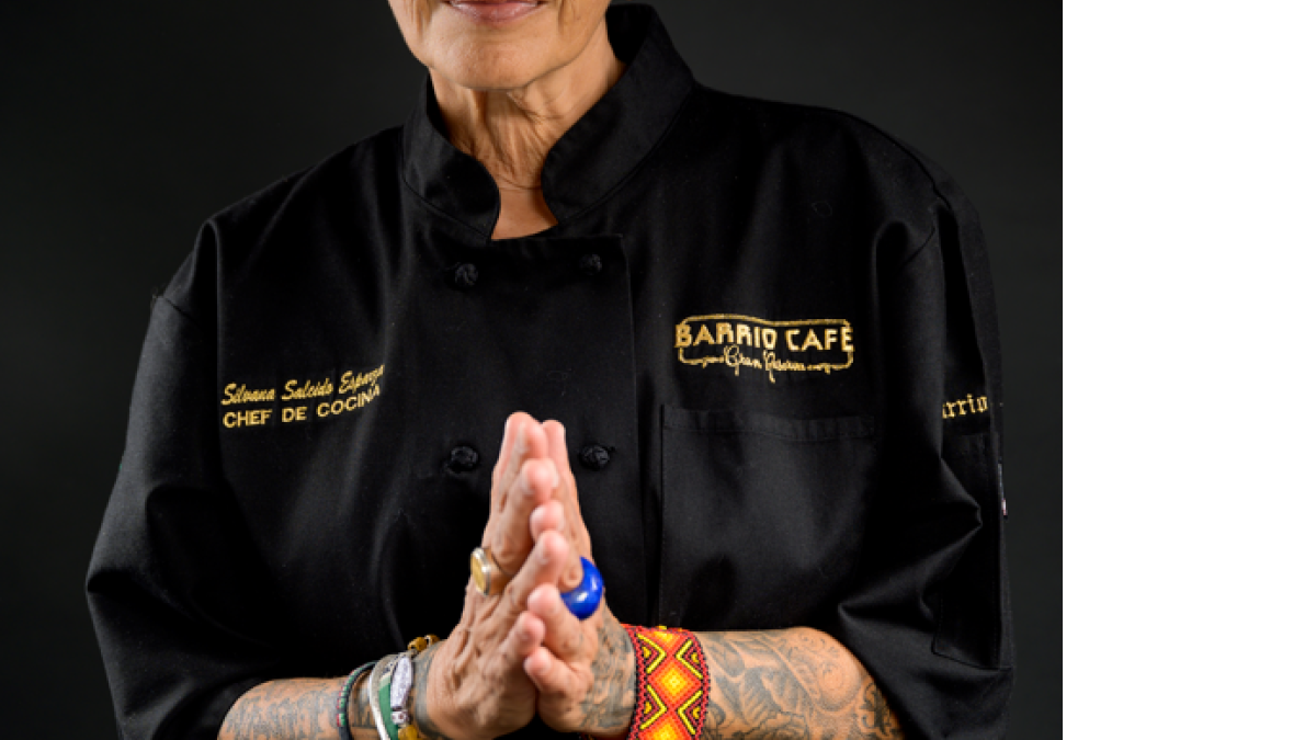 Portrait of Phoenix chef Silvana Salcido Esparza in a chef coat with hands pressed together.