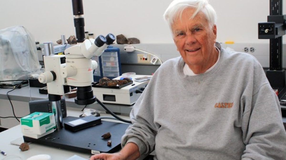 ASU Emeritus Regents Professor Carleton Moore seated in a lab in front of a microscope