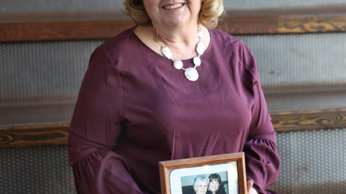A senior program coordinator on ASU’s Polytechnic Campus, Carolyn Starr displays a photo of her mother who she was able to visit with the help of the Staff Helping Staff Fund.