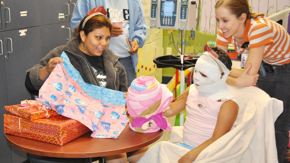 Child life specialists work with a young patient. 
