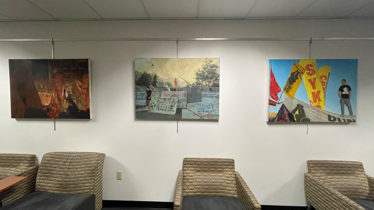 Paintings by artist Chris Vena on display in a hallway at ASU's University Center as part of the Watts College for Public Service and Community Solutions program "Action, Advocacy and Art."