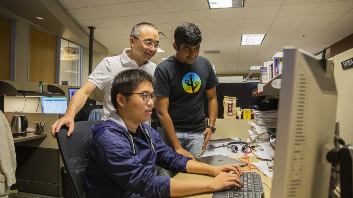 Professor Huan Liu works with his students in the Data Mining and Machine Learning Lab