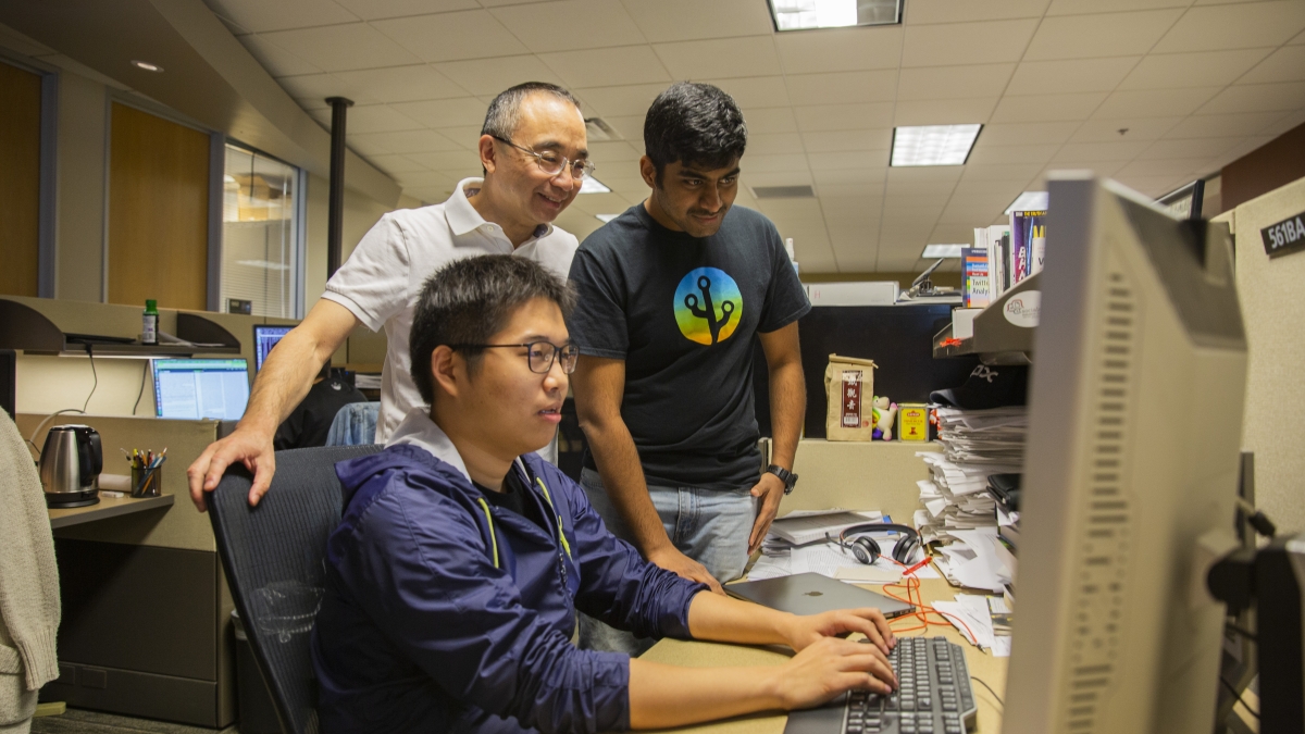 Professor Huan Liu works with his students in the Data Mining and Machine Learning Lab