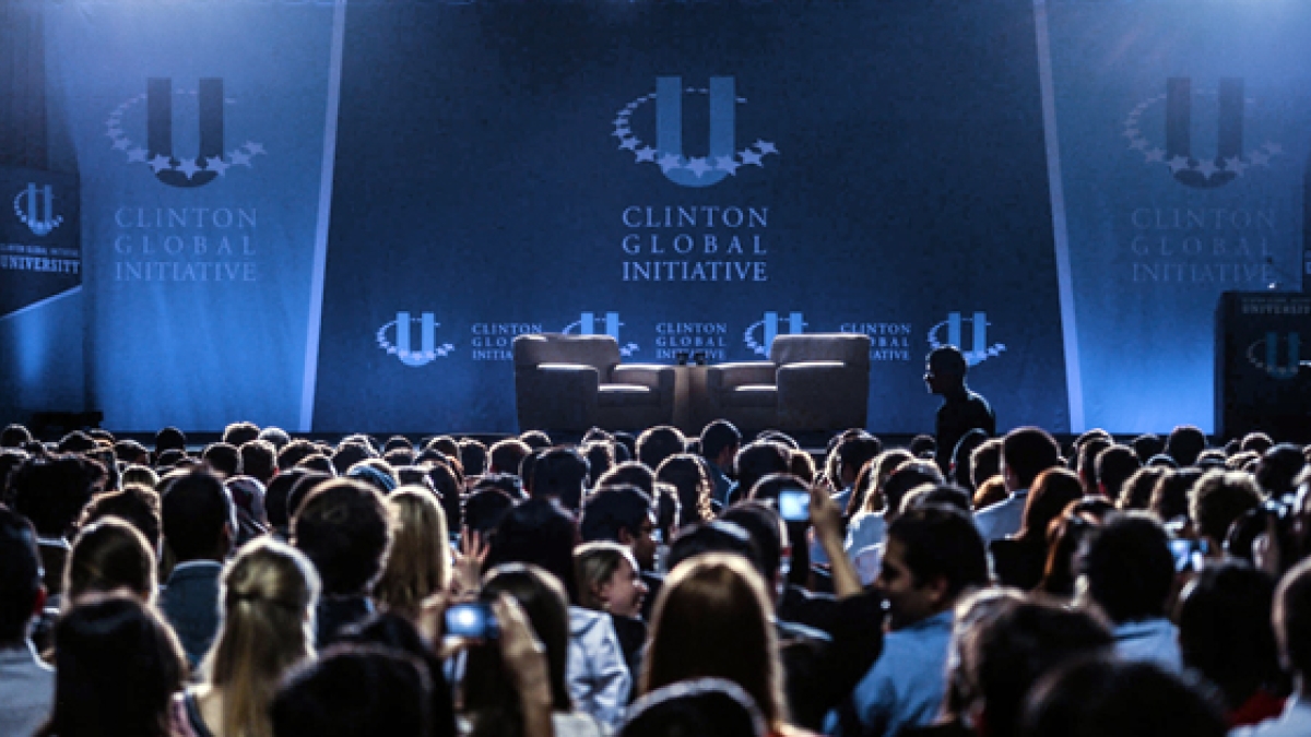 Picture of conference stage with a filled room of attendees