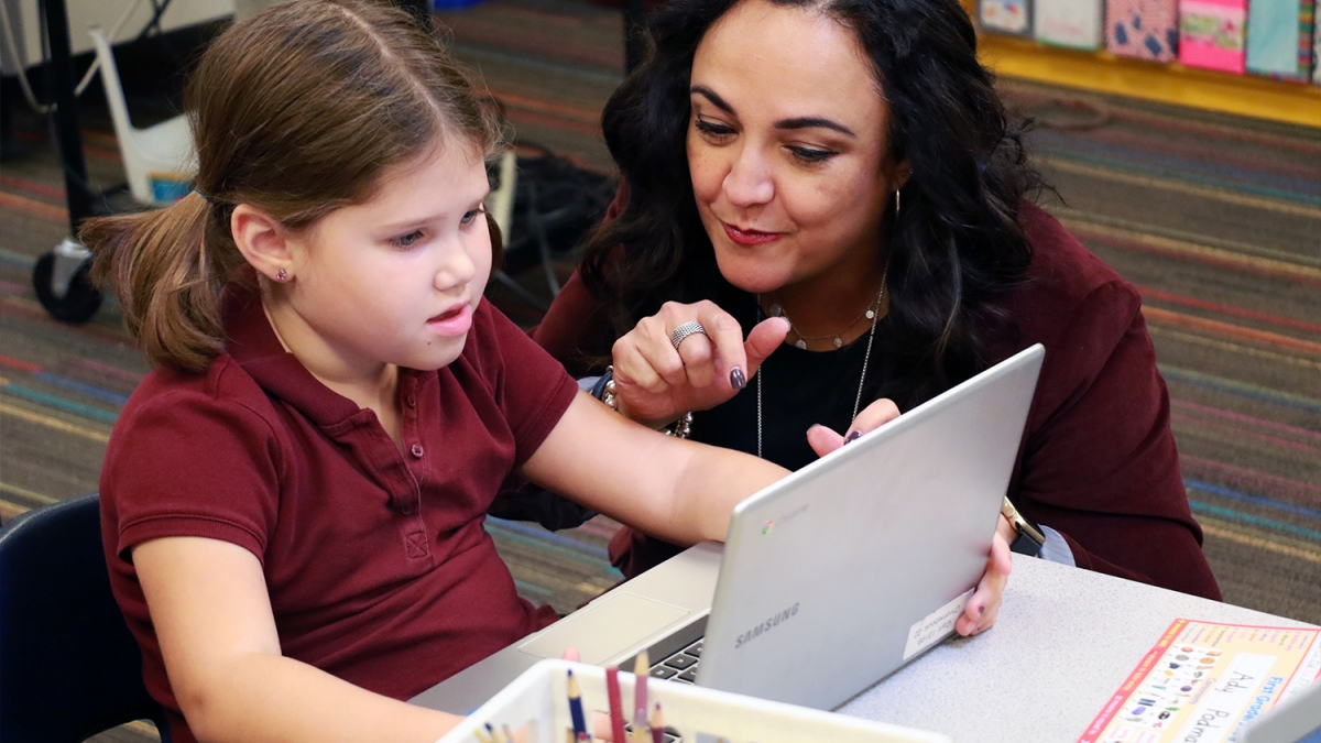 ASU Prep Poly STEM Academy Principal Claudia Mendoza works with a student on a computer