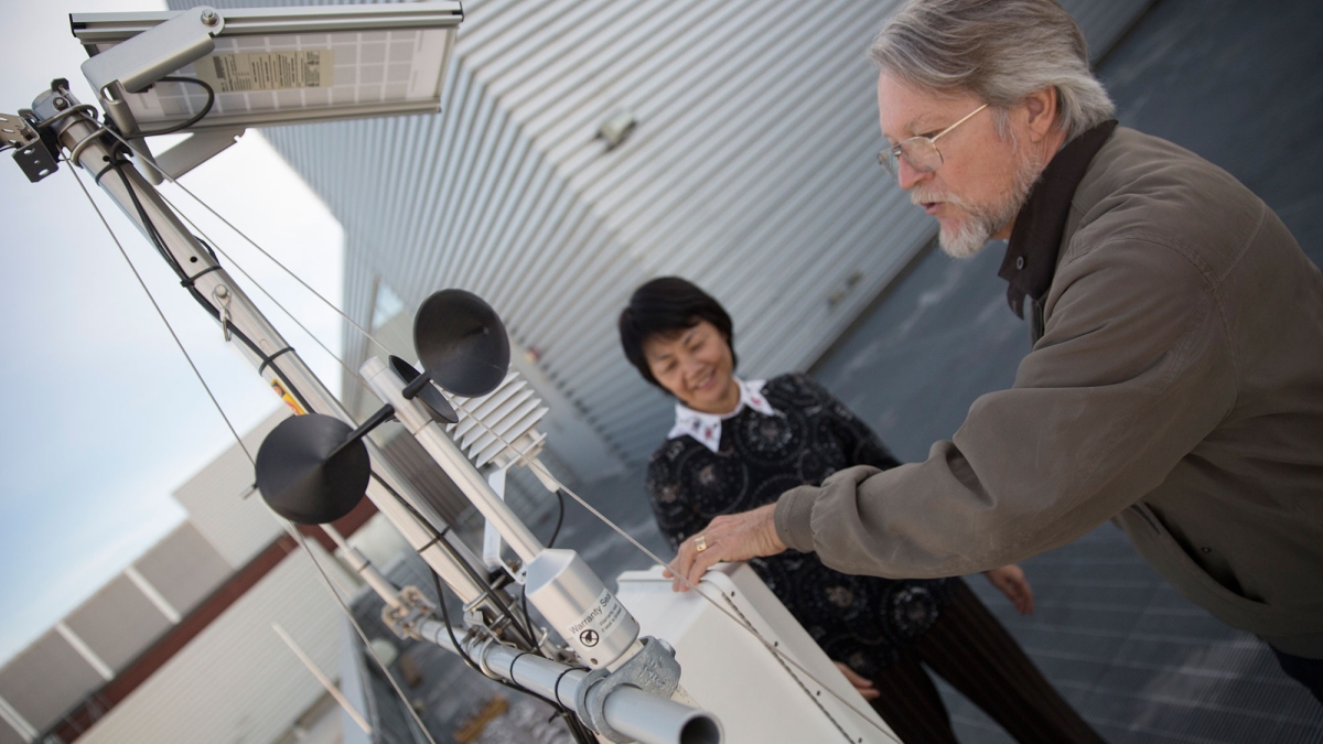 Allen Wright and Yun Ge check on the weather station used by researchers at ASU