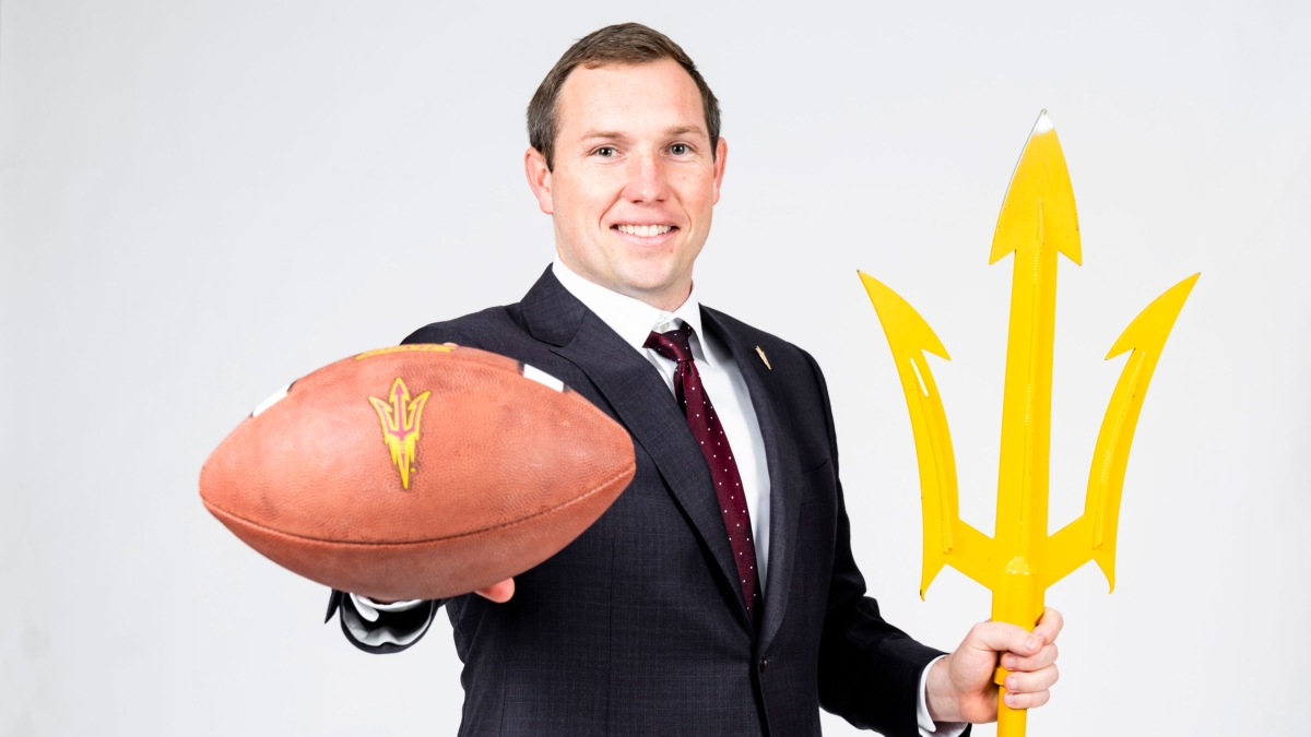 Portrait of coach with football and pitchfork