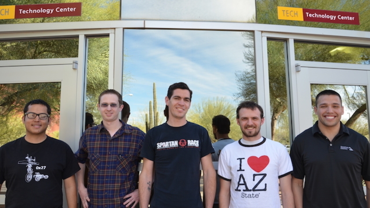 group photo of five ASU students in front of building