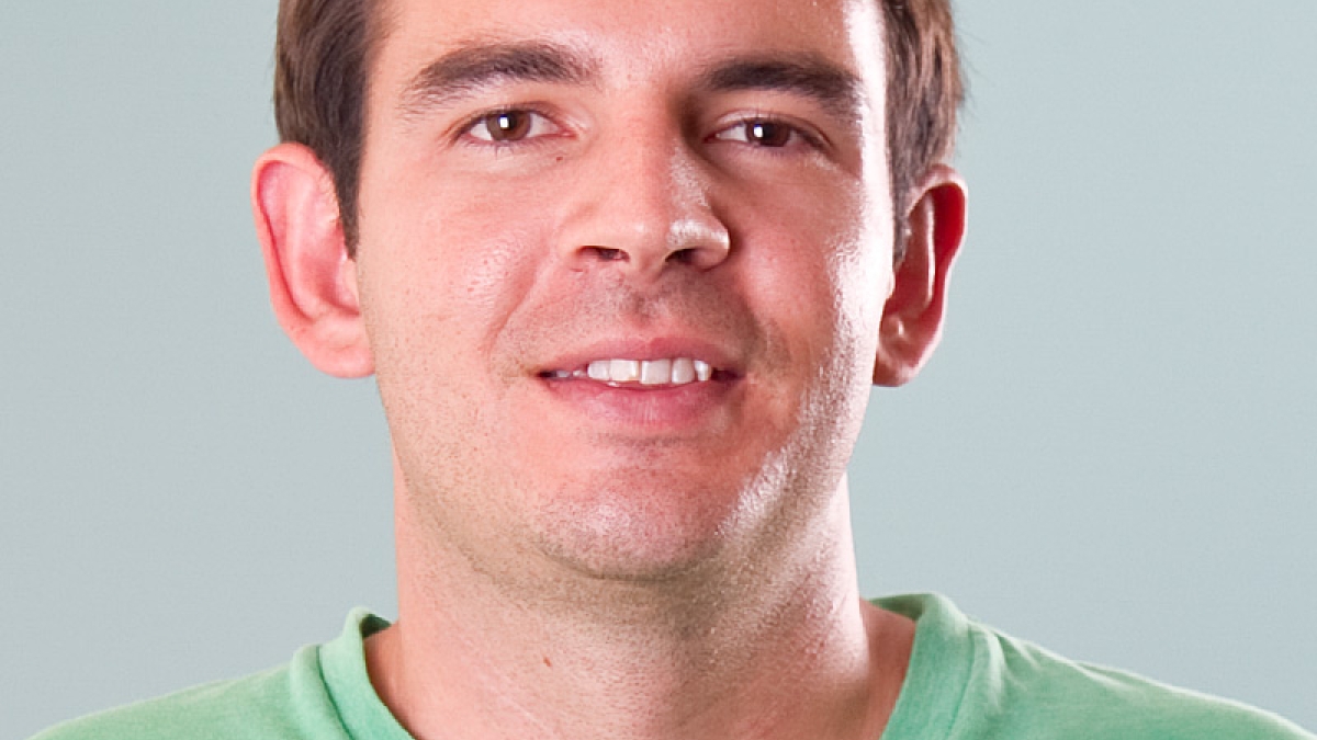 headshot of male Daniel Culotta wearing green t-shirt with brown hair and eyes