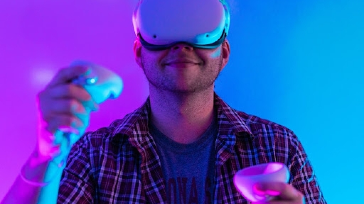 Student wearing a VR headset and holding VR controllers.