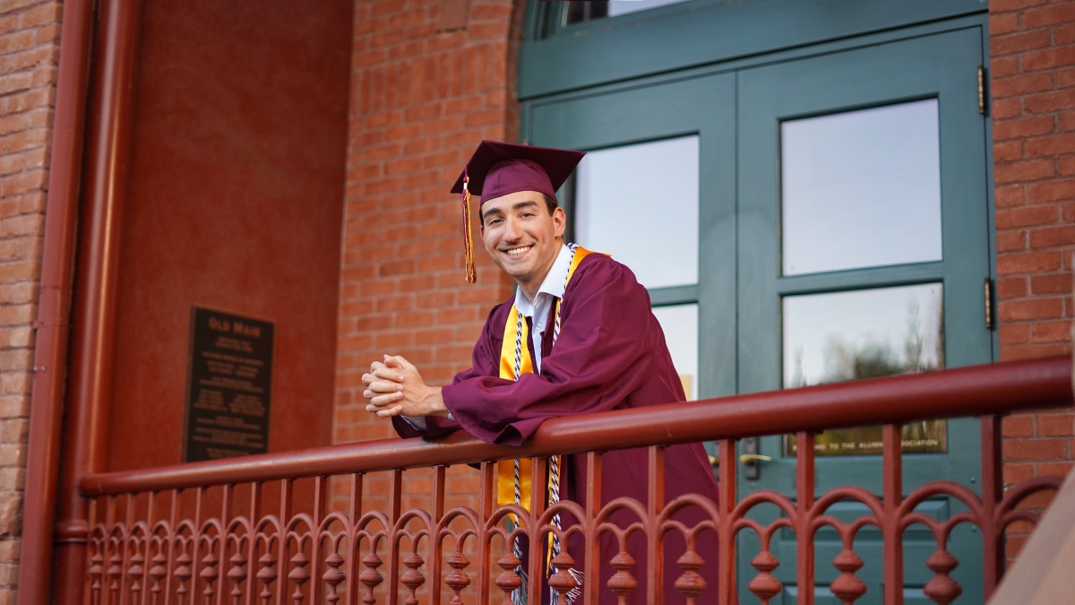 ASU grad Dominic Frattura in his cap and gown at Old Main