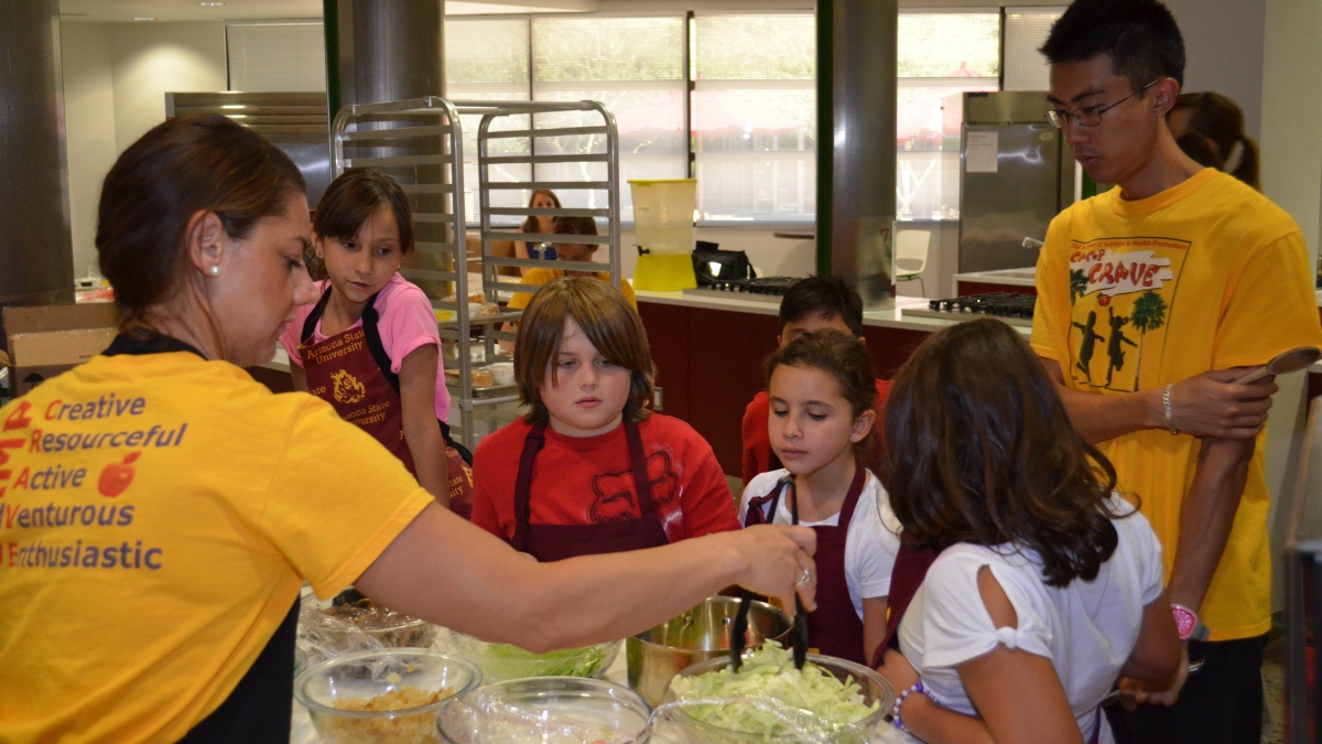 ASU nutrition student Amy Christman shows campers how to cook healthy meals.