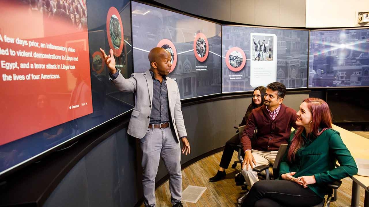 a group goes through a training simulation at Decision Theater