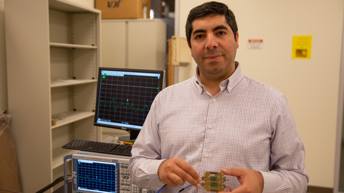 Saeed Zeinolabedinzadeh poses with an integrated circuit developed in his Millimeter-Wave, Terahertz and Photonic Integrated Circuits Lab.