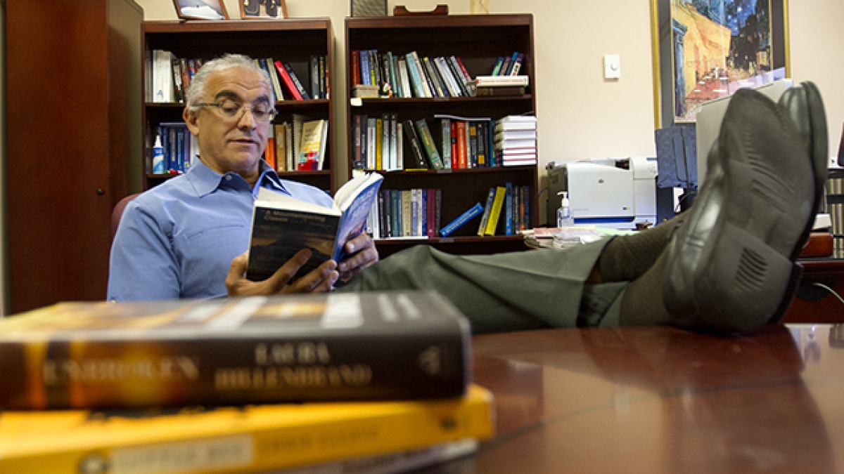 professor reading books at his desk