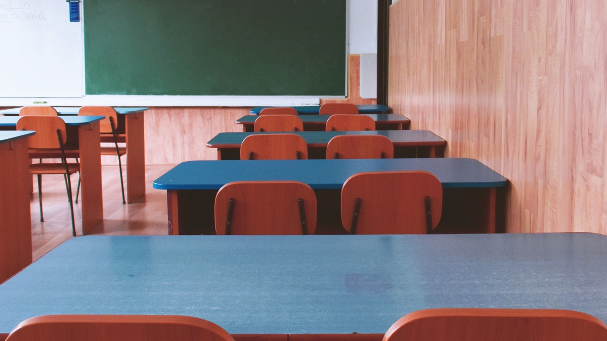rows of empty desks in classroom