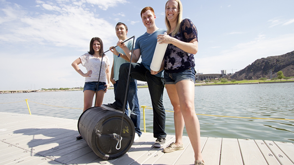 four students on a dock