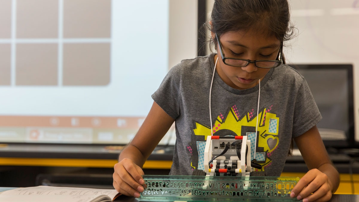 A student tests her LEGO robot at the FIRST LEGO League summer camp.