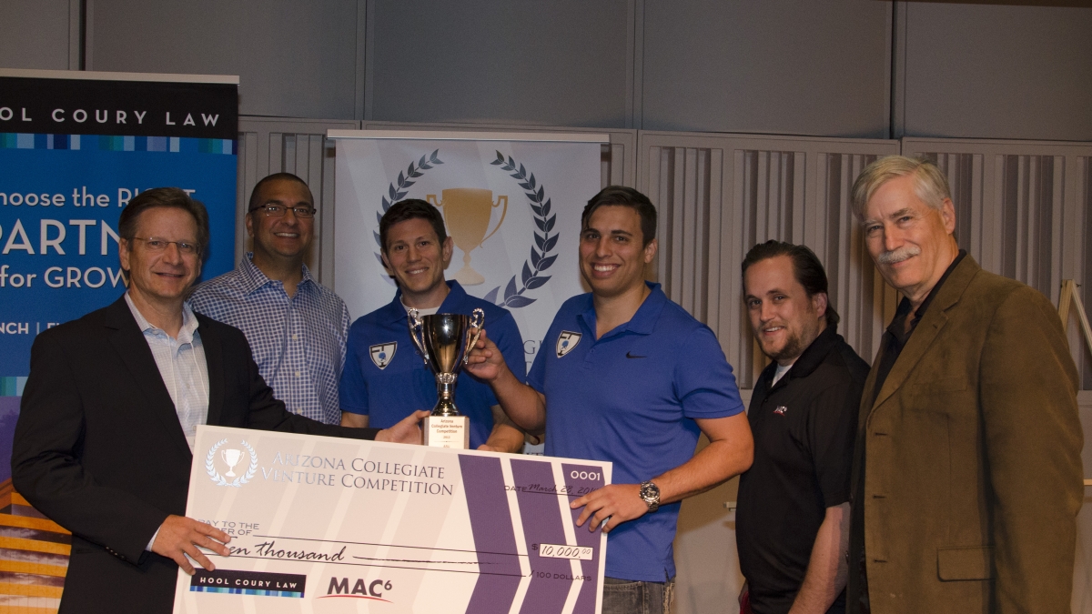 ASU students pose with trophy at startup competition