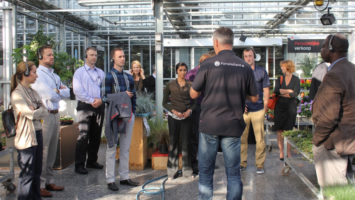 group of students inside Amsterdam&#039;s FloraHolland greenhouse