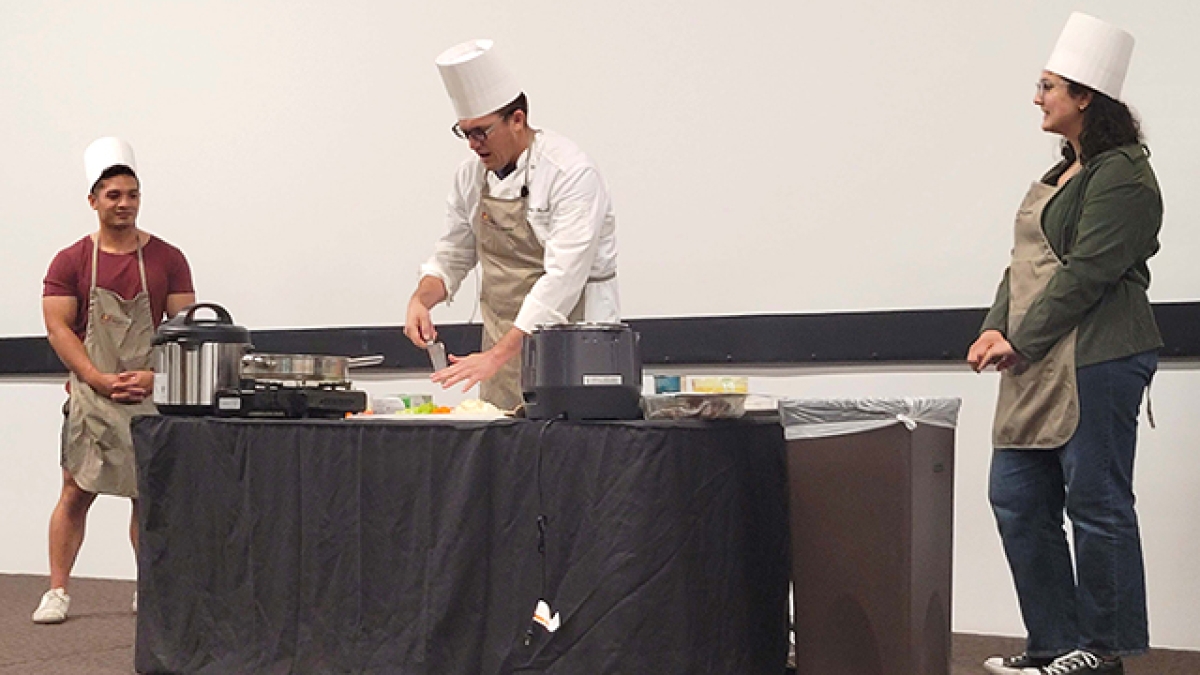 Chef Kenneth Moody demonstrates chopping ingredients for use in a pressure cooker.