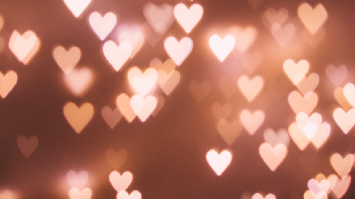 A bunch of blurry light-filtered hearts against a plain background.