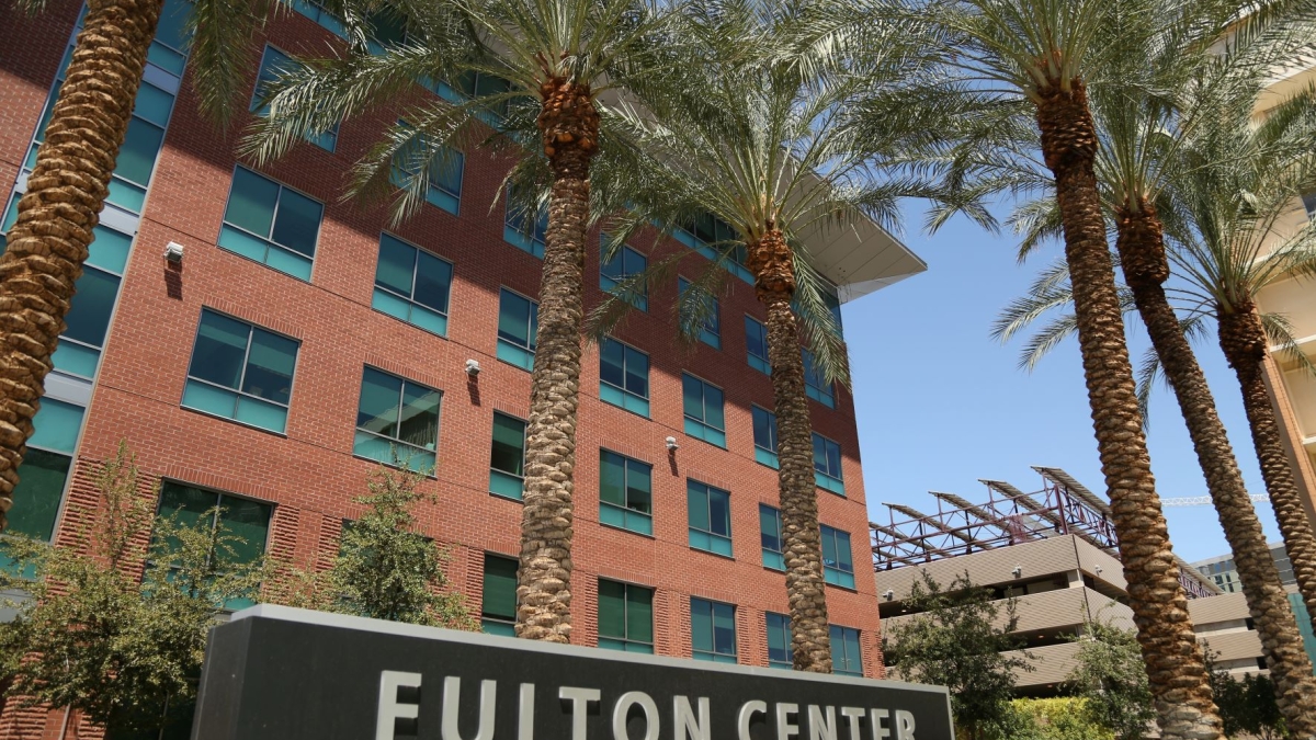 Exterior shot of Fulton Center with sign and palm trees