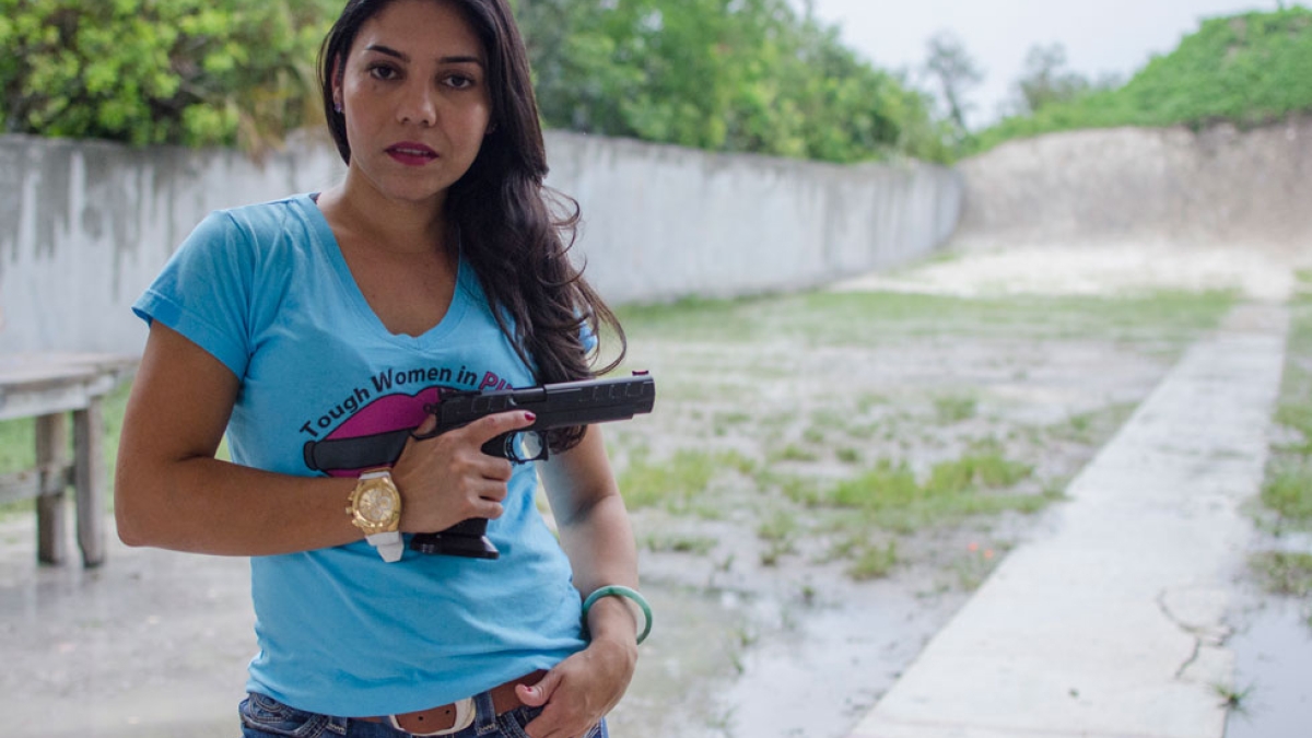 woman posing with hand gun
