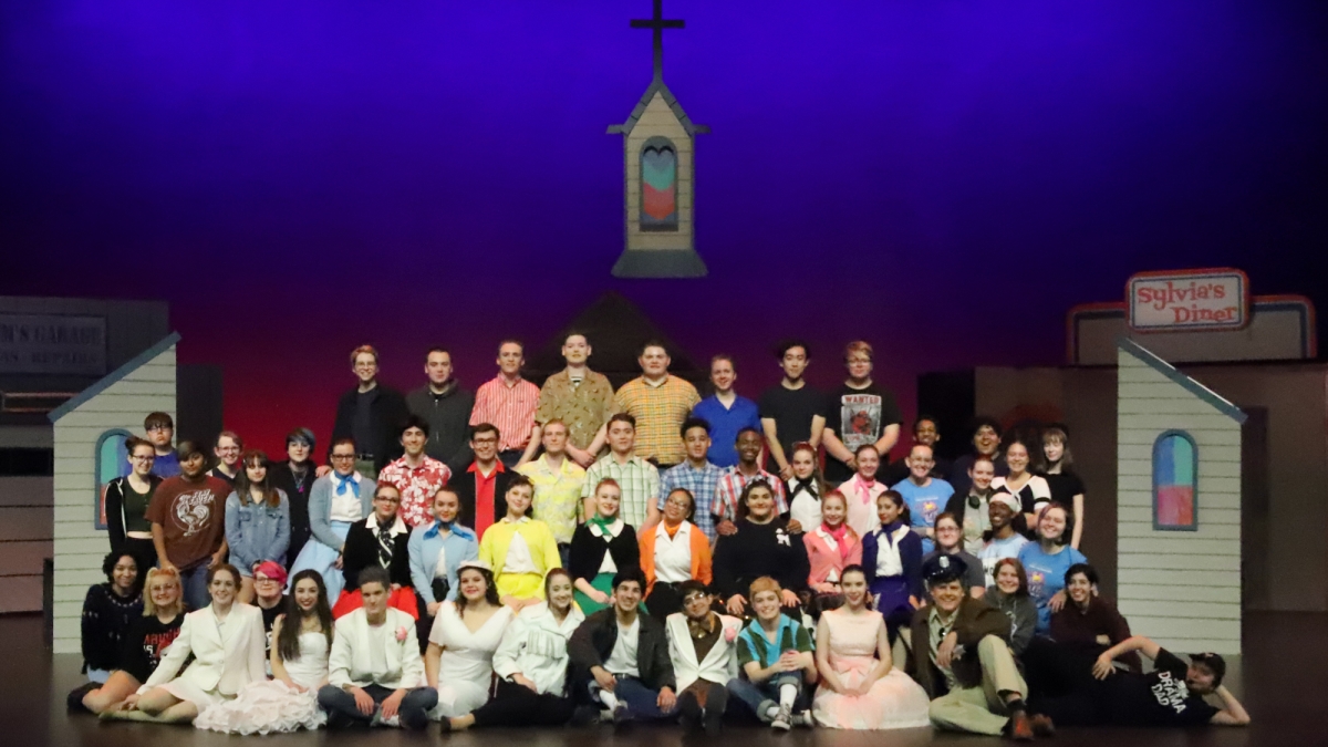 group photo of high school theater students on stage