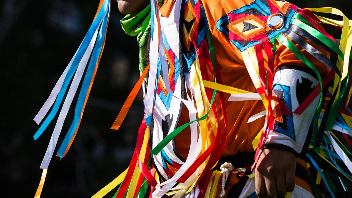 man dancing in traditional Native American dress