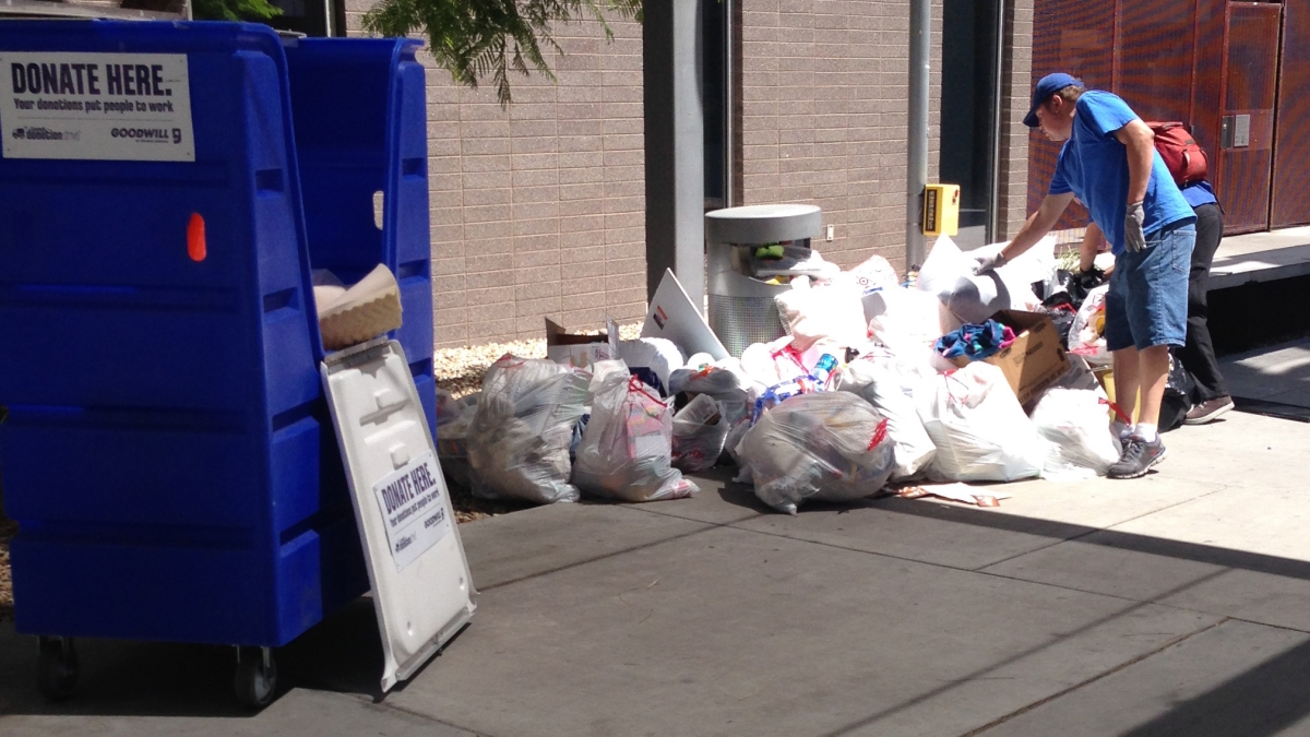 Photo of Goodwill staff inspecting waste during Ditch the Dumpster donation event