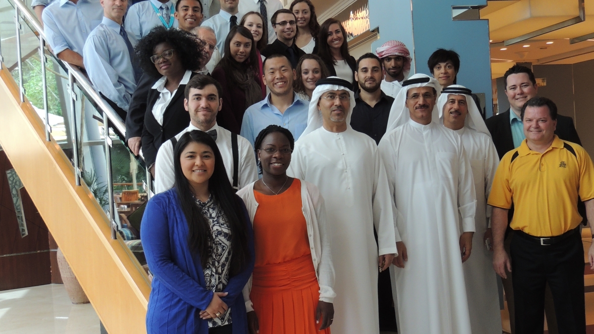 interior group photo of His Excellency, program leaders, and students in Dubai