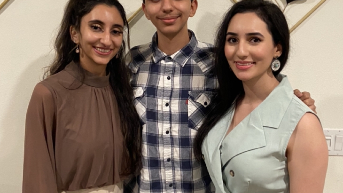 three siblings smiling for a photo