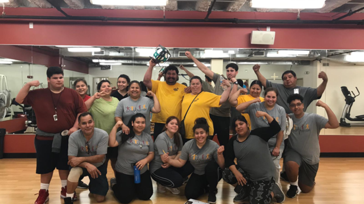 Participants in a study aimed at Latino children predisposed to diabetes pose for a group photo after a physical fitness class at the YMCA