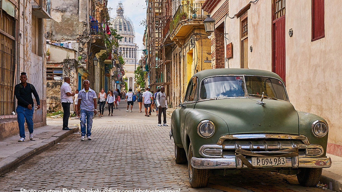Residents and tourists walk a street near the Cuban capital. 