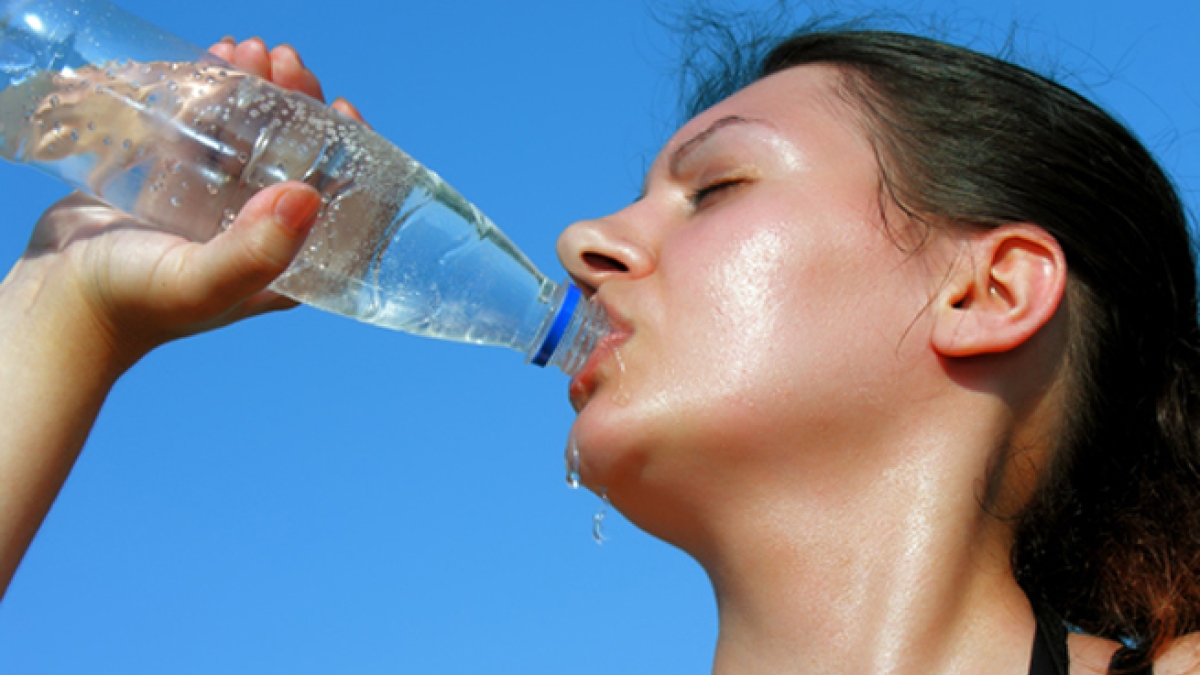 woman drinking water in the heat
