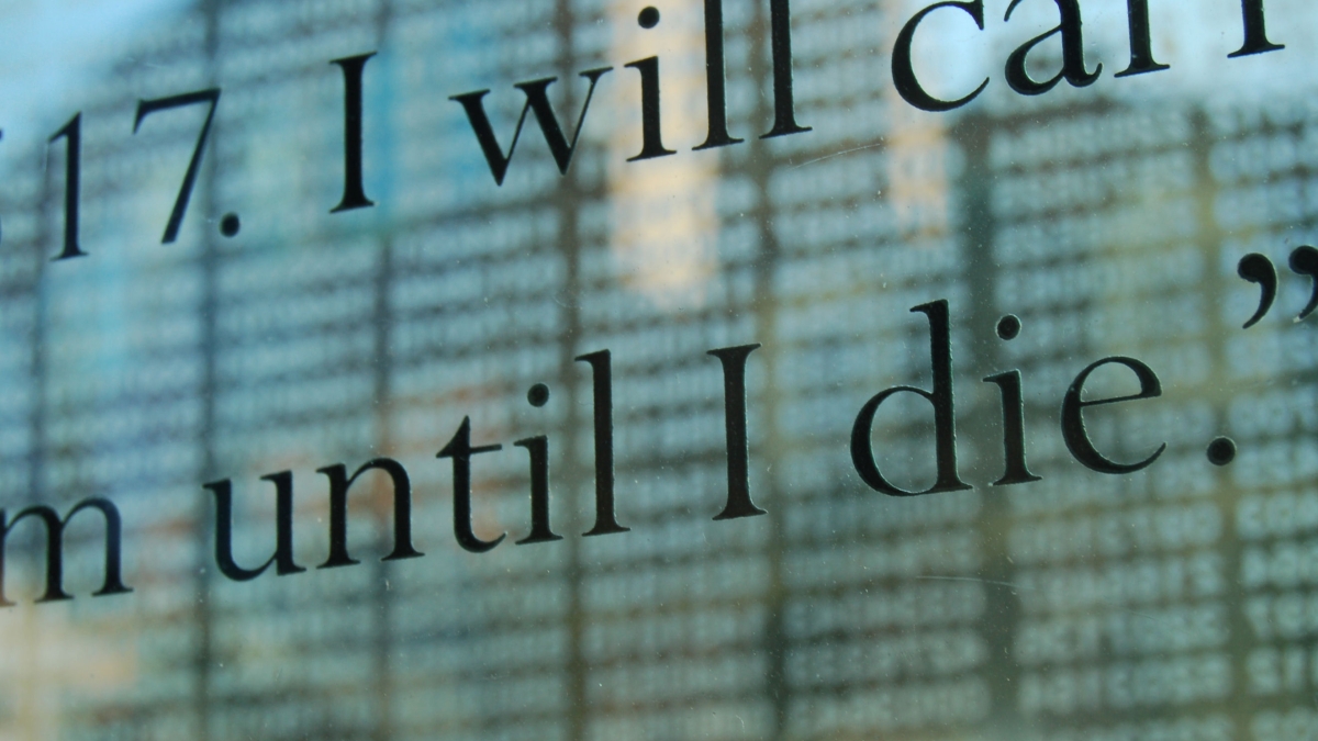 Close-up of words inscribed on a Holocaust memorial. The words "I will" and "until I die" are visible.
