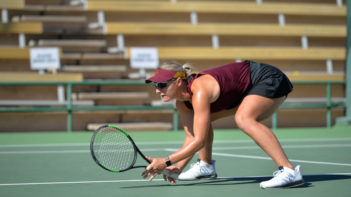 Ilze Hattingh, Sun Devil, crouches on the court while playing women's tennis