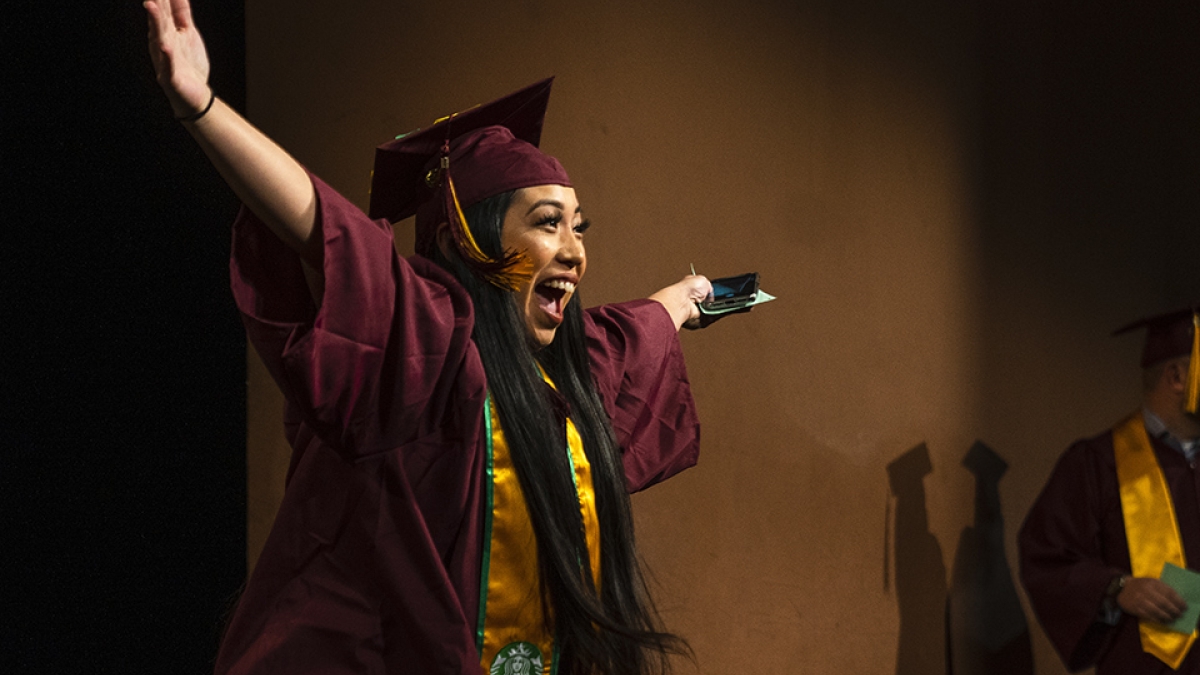 a graduate celebrates at the fall 2019 convocation for the Walter Cronkite School of Journalism and Mass Communication