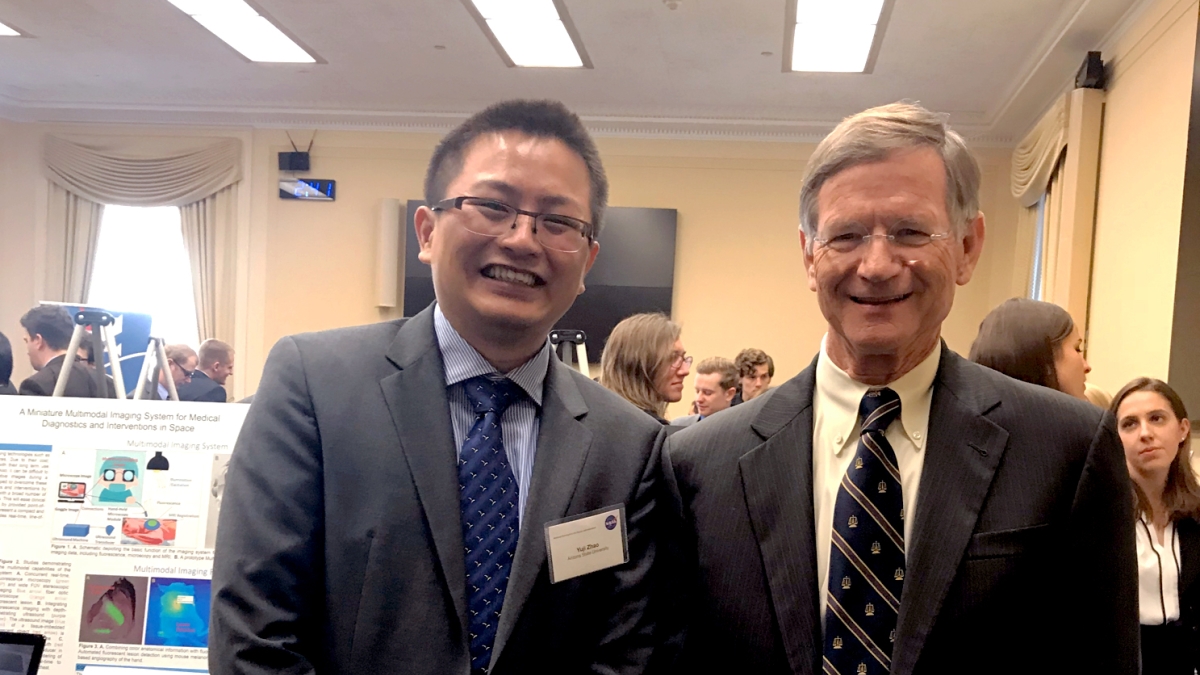Yuji Zhao (left) poses with U.S. Representative Lamar Smith, chairman of the Committee on Science, Space, and Technology.