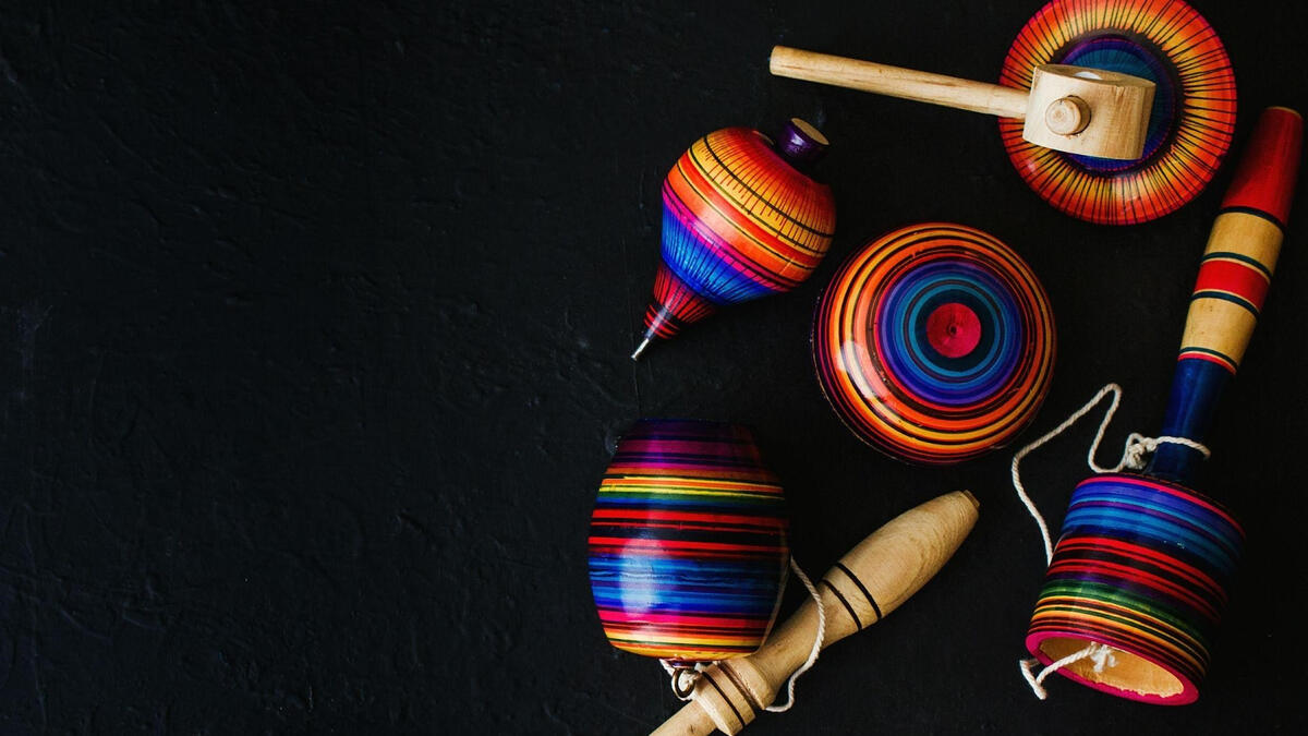 Brightly colored wooden toys on a black background.