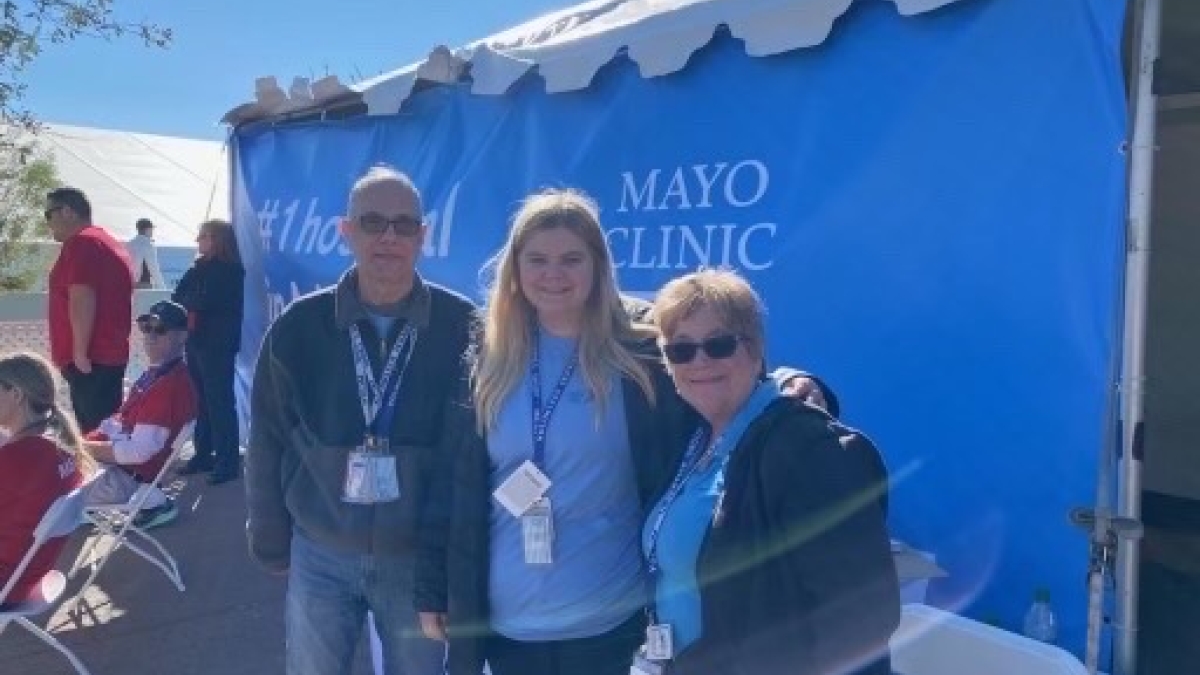 ASU student Hannah Lux poses for a photo with two members of the Maricopa County Department of Public Health outside of a tent at the WM Phoenix Open.