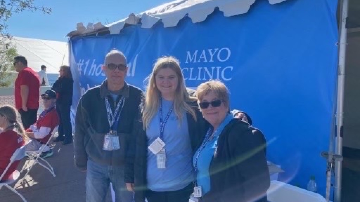 ASU student Hannah Lux poses for a photo with two members of the Maricopa County Department of Public Health outside of a tent at the WM Phoenix Open.