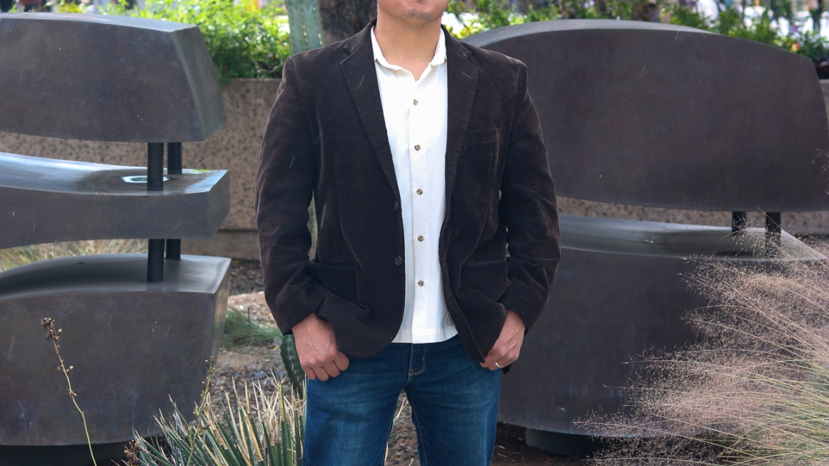 Francisco Pedraza, Arizona State University associate professor in the School of Politics and Global Studies, wearing jeans and a blazer outside on the Tempe campus.
