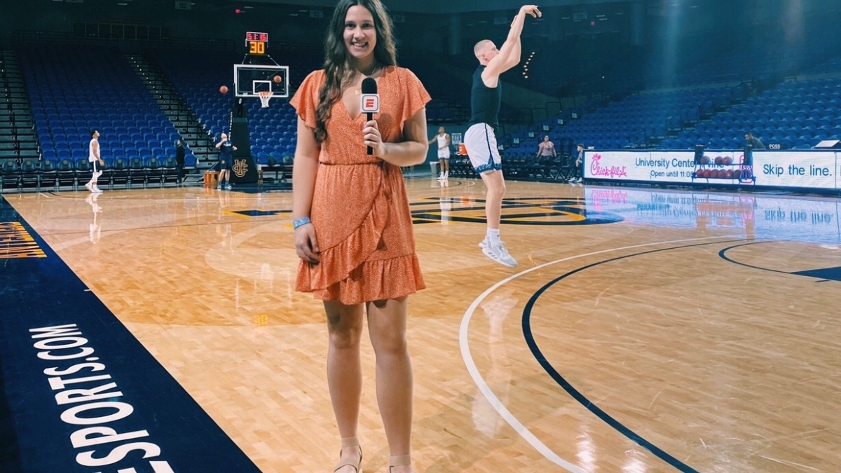 Woman reporting on basketball game