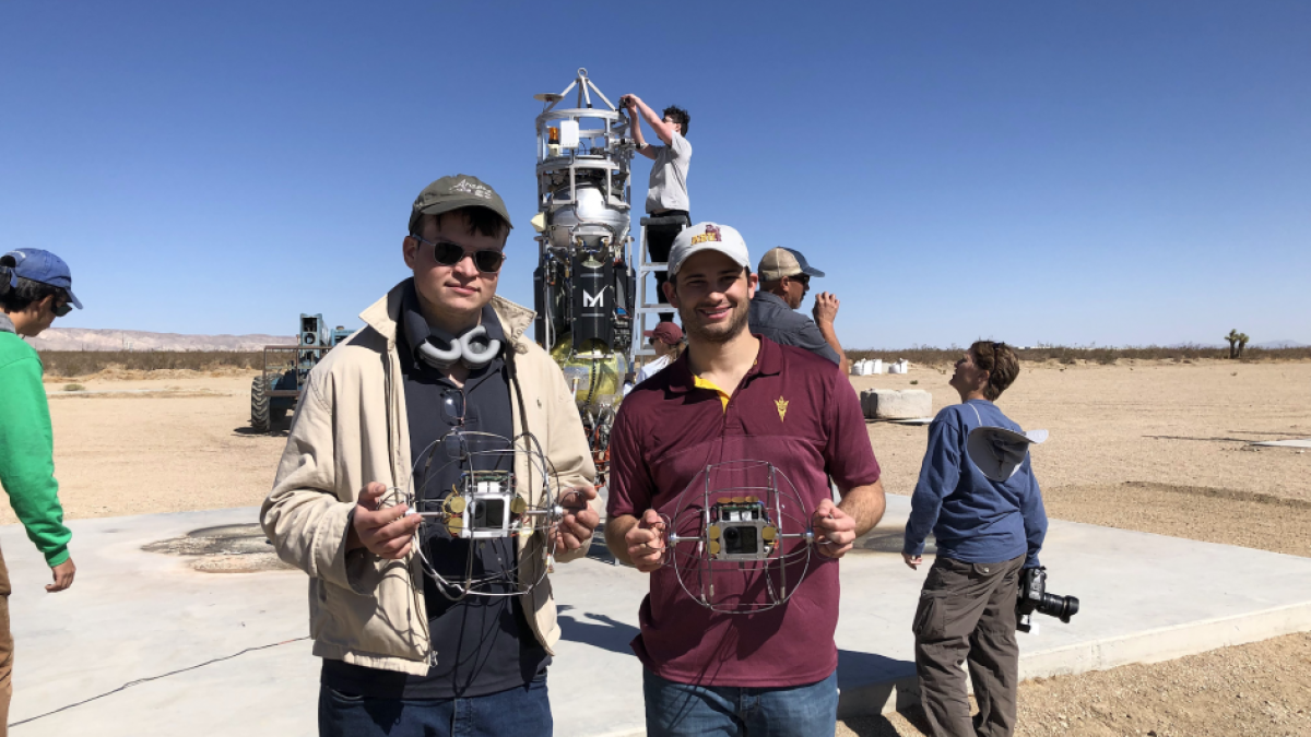 ASU students hold ExoCam prototypes for a NASA mission.