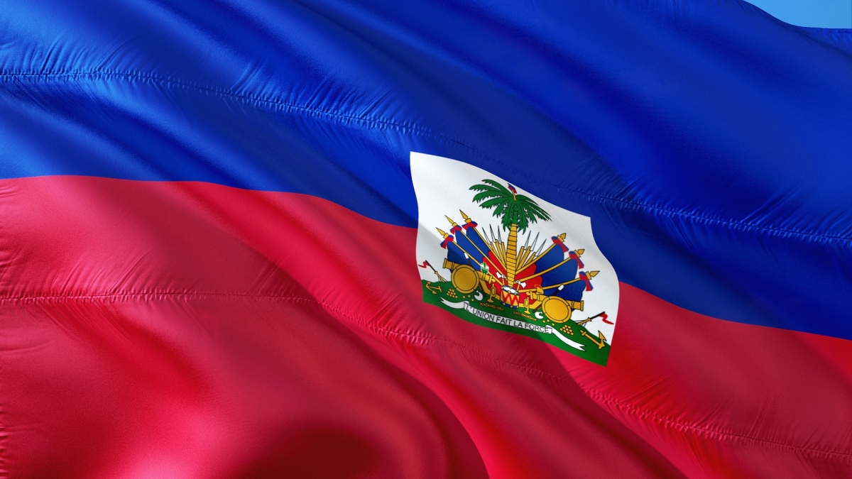 The Haitian flag behind a blue sky
