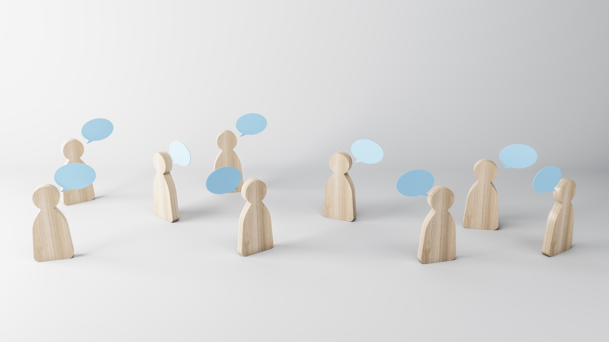stock photo of wooden people with conversation bubbles
