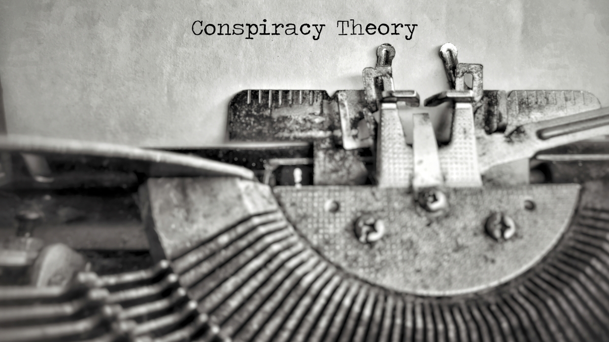 Stock image of typewriter typing Conspiracy Theory