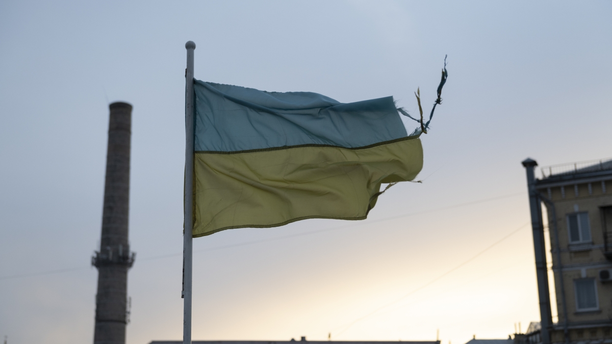 A weathered Ukrainian flag flying in Kyiv.